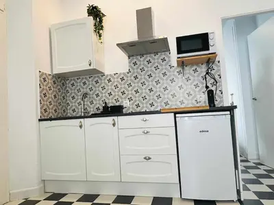 a kitchen with white cabinets and a checkered floor at Casa Las 4 Esquinas by Casas con Encanto in Medina Sidonia