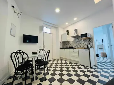 a kitchen with a table and chairs in a room at Casa Las 4 Esquinas by Casas con Encanto in Medina Sidonia