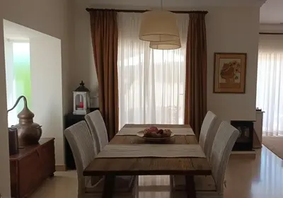 a dining room table with chairs and a bowl of fruit on it at Casa Los Olivos in Arcos de la Frontera