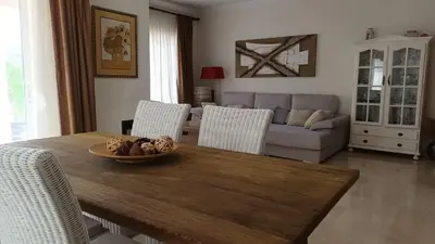 a living room with a table and a couch at Casa Los Olivos in Arcos de la Frontera