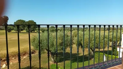 a fence with a view of a field at Casa Los Olivos in Arcos de la Frontera