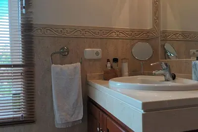 a bathroom with a sink and a mirror at Casa Los Olivos in Arcos de la Frontera