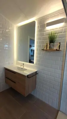 a bathroom with a sink and a mirror at Apartamento Mistral 5, con piscina y parking. in Chiclana de la Frontera