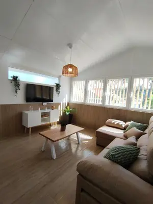a living room with a couch and a table at Apartamento Mistral 5, con piscina y parking. in Chiclana de la Frontera