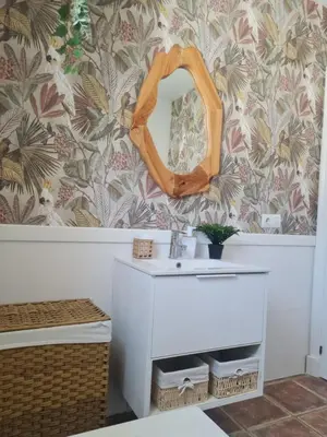 a bathroom with a sink and a mirror on a wall at Villa Encanto in Chiclana de la Frontera