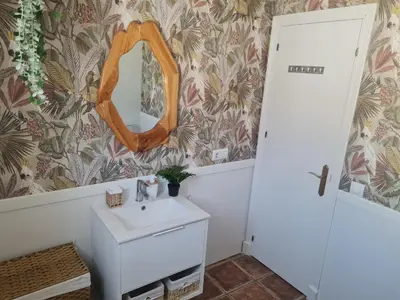 a bathroom with a sink and a mirror on the wall at Villa Encanto in Chiclana de la Frontera