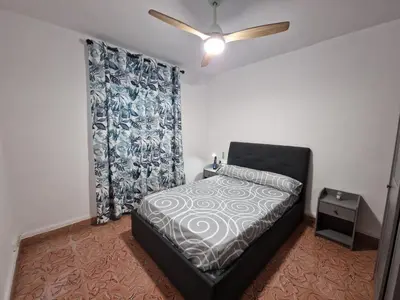 a bedroom with a bed and a ceiling fan at DULCE CARMEN in Bonanza