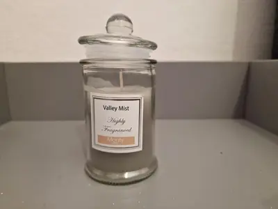 a candle in a glass jar on a counter at DULCE CARMEN in Bonanza