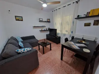 a living room with a couch and a table at DULCE CARMEN in Bonanza