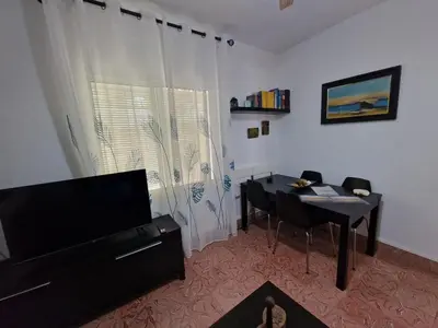 a living room with a table and a dining room table at DULCE CARMEN in Bonanza