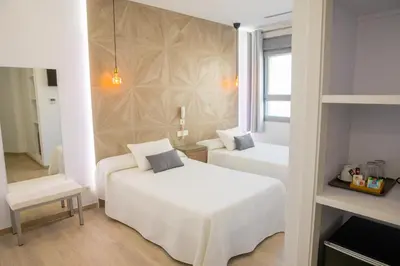 a hotel room with two beds and a window at Apartahotel Énfasis-Group in El Cuervo