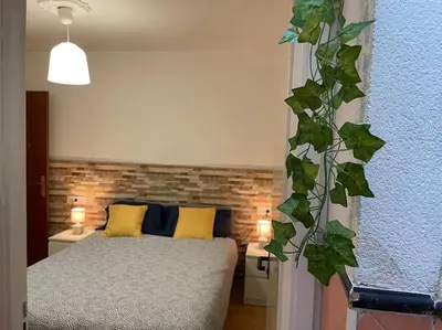 a bedroom with a bed and a brick wall at Casa Oceano in San Fernando