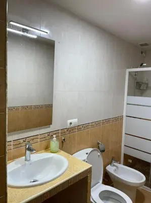 a bathroom with a sink and a toilet and a mirror at Casa Oceano in San Fernando