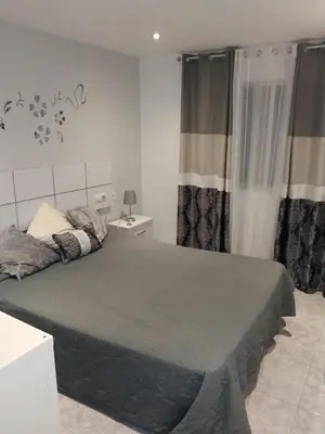 a bedroom with a large bed in a room at piso pilar in Chiclana de la Frontera
