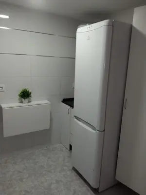 a kitchen with a white refrigerator and a sink at piso pilar in Chiclana de la Frontera