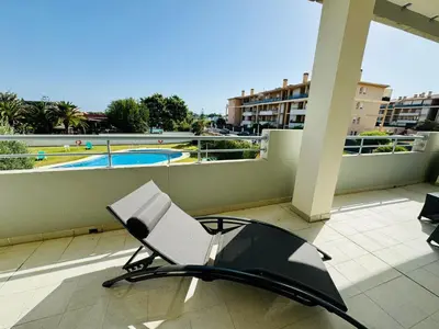 a balcony with a chair and a swimming pool at Casa La Camelia con Piscina Grupo AC Gestión in El Puerto de Santa María