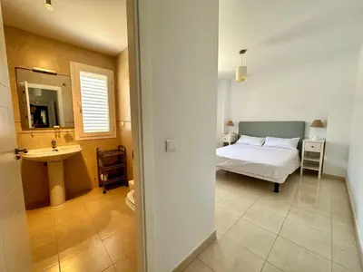 a bedroom with a bed and a sink in it at Casa La Camelia con Piscina Grupo AC Gestión in El Puerto de Santa María