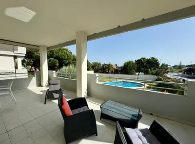 an outdoor patio with chairs and a swimming pool at Casa La Camelia con Piscina Grupo AC Gestión in El Puerto de Santa María