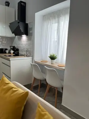 a kitchen with a table and chairs in a room at Apartamento 29 in Arcos de la Frontera