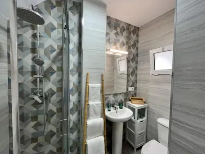 a bathroom with a sink and a toilet and a shower at Apartamento 29 in Arcos de la Frontera