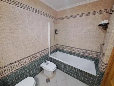 a bathroom with a bath tub and a toilet at Ático primera línea de playa con vistas al Mar-Climatizado-Wifi-Parking-Solo familias in El Puerto de Santa María
