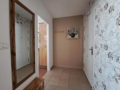 a hallway with a door and a mirror in a room at Ático primera línea de playa con vistas al Mar-Climatizado-Wifi-Parking-Solo familias in El Puerto de Santa María
