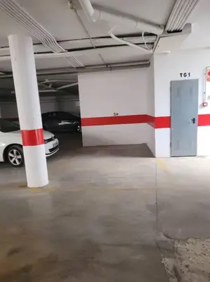 a parking garage with a car parked in it at Casa San Lucas - Corazón del Casco Histórico con piscina y parking in Jerez de la Frontera
