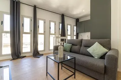 a living room with a couch and a table at Allo Apartments Santa Maria I Centro 1 Habitación in Jerez de la Frontera
