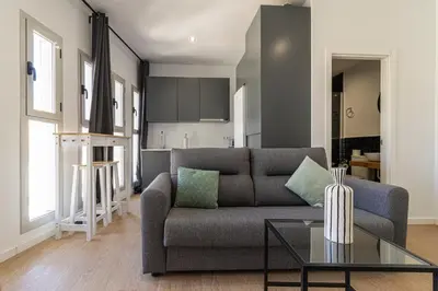 a living room with a couch and a table at Allo Apartments Santa Maria I Centro 1 Habitación in Jerez de la Frontera