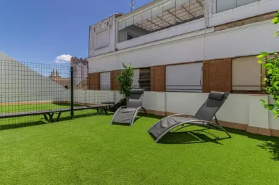 a patio with two chairs and a tent on the grass at Allo Apartments Santa Maria I Centro 1 Habitación in Jerez de la Frontera