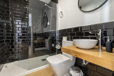 a bathroom with a toilet and a sink and a shower at Allo Apartments Santa Maria I Centro 1 Habitación in Jerez de la Frontera