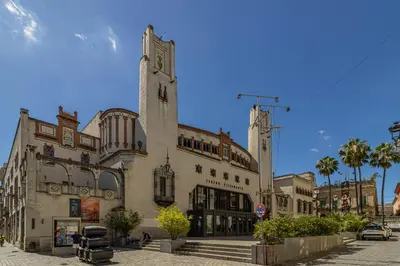 a large building with a clock tower on a street at Allo Apartments Santa Maria I Centro 1 Habitación in Jerez de la Frontera
