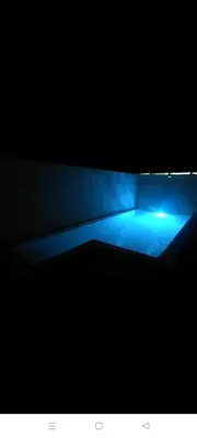 a blue light on a bed in the dark at Villa nazaret in Chiclana de la Frontera