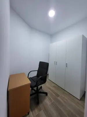 an office with a chair and a desk and cabinets at Apartamento Parque Bahía in Puerto Real