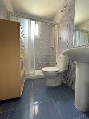 a bathroom with a toilet and a sink at ÁTICO BAJO GUÍA in Sanlúcar de Barrameda