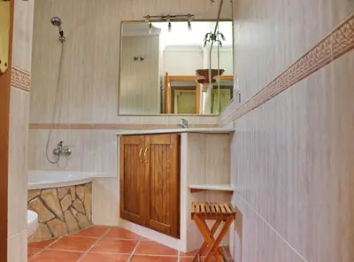 a bathroom with a sink and a tub and a mirror at Casa El Oasis in Conil de la Frontera