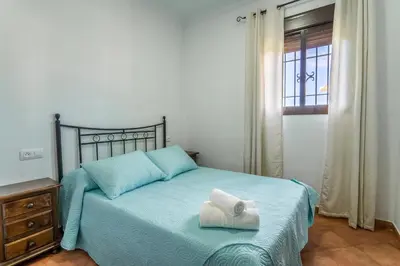a bedroom with a bed with a towel on it at EntreCalas 2 Chalet con piscina privada en Conil, Roche viejo, cala del aceite in Conil de la Frontera