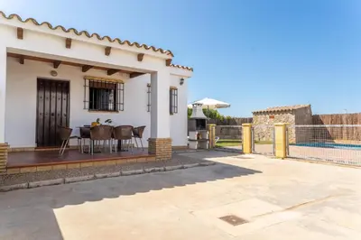 a villa with a view of the patio of a house at EntreCalas 2 Chalet con piscina privada en Conil, Roche viejo, cala del aceite in Conil de la Frontera