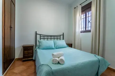 a bedroom with a bed with two towels on it at EntreCalas 2 Chalet con piscina privada en Conil, Roche viejo, cala del aceite in Conil de la Frontera