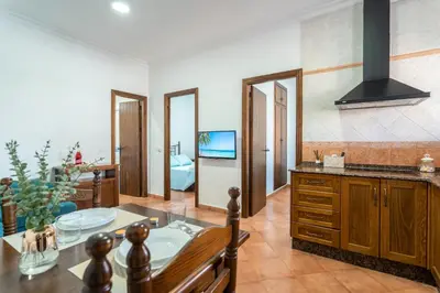 a kitchen with a table and a dining room at EntreCalas 2 Chalet con piscina privada en Conil, Roche viejo, cala del aceite in Conil de la Frontera