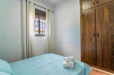 a bedroom with a bed with two towels on it at EntreCalas 2 Chalet con piscina privada en Conil, Roche viejo, cala del aceite in Conil de la Frontera