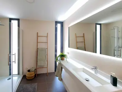 a bathroom with a sink and a large mirror at La Casetta de Conil junto a la playa in Conil de la Frontera