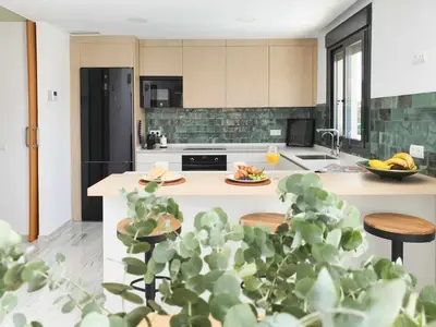 a kitchen with a island with food on it at La Casetta de Conil junto a la playa in Conil de la Frontera