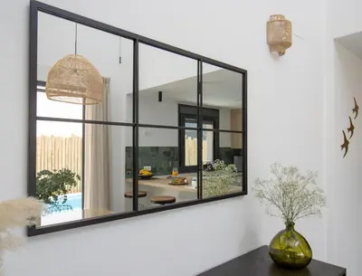 a large mirror on a wall in a living room at La Casetta de Conil junto a la playa in Conil de la Frontera