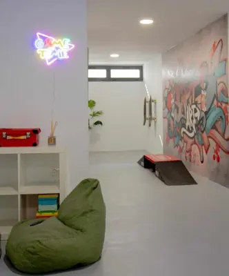 a room with a green bean chair and a wall with graffiti at La Casetta de Conil junto a la playa in Conil de la Frontera