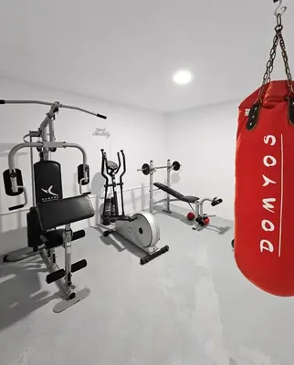 a gym with two exercise bikes and a punching bag at La Casetta de Conil junto a la playa in Conil de la Frontera