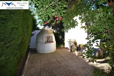 a small house in a garden with plants at Villa Aurora in Cádiz