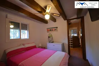 a bedroom with a bed and a ceiling fan at Villa Aurora in Cádiz