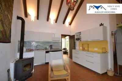 a kitchen with a fireplace and a stove at Villa Aurora in Cádiz