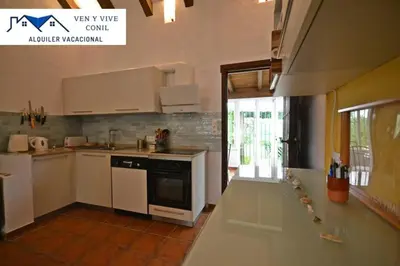a kitchen with white cabinets and a stove at Villa Aurora in Cádiz